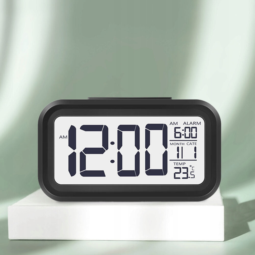 Elektroniskais modinātājs ar fona apgaismojumu